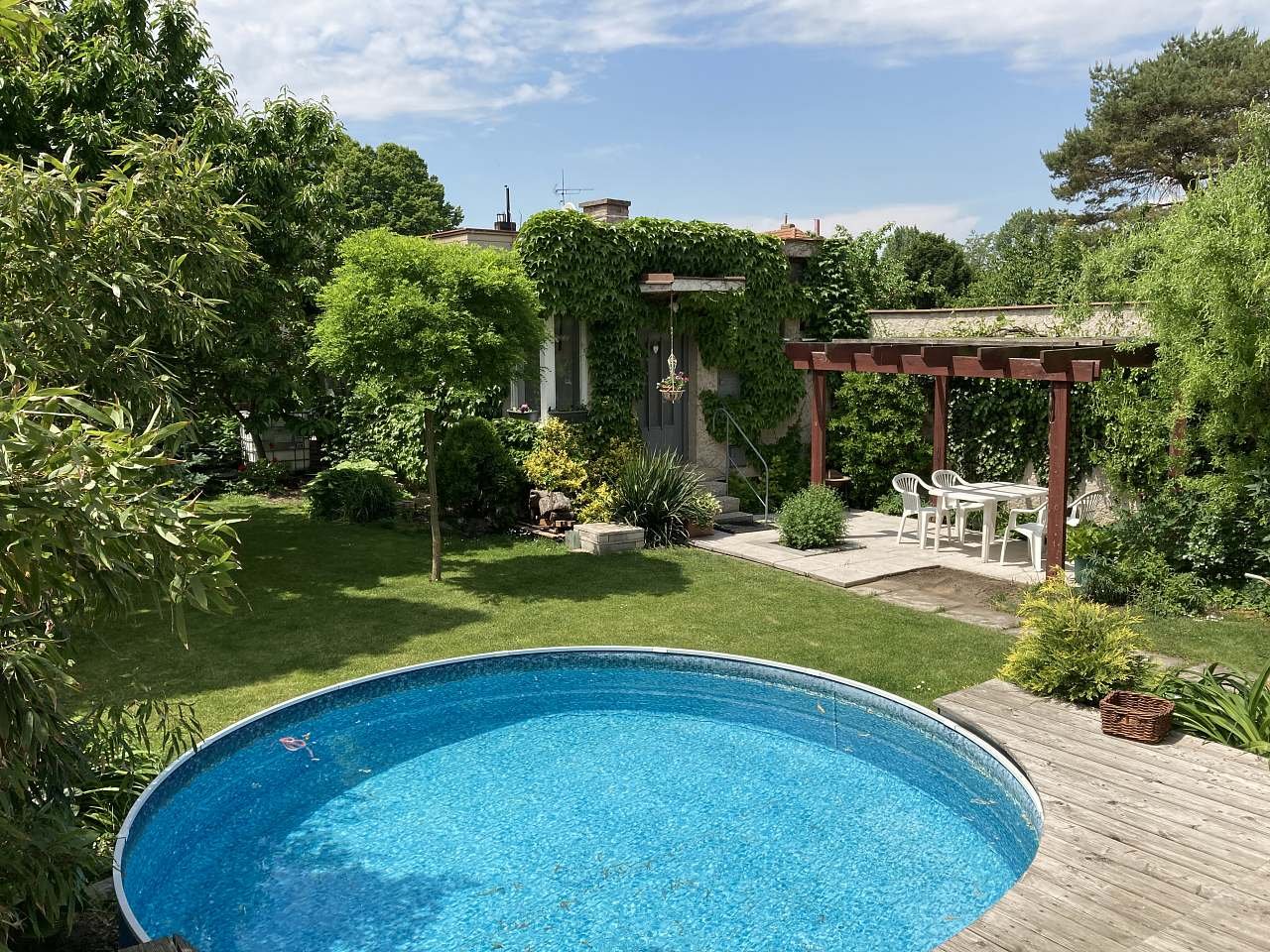 Malý bazénem na zahradě s apartmánem a otevřenou pergolou