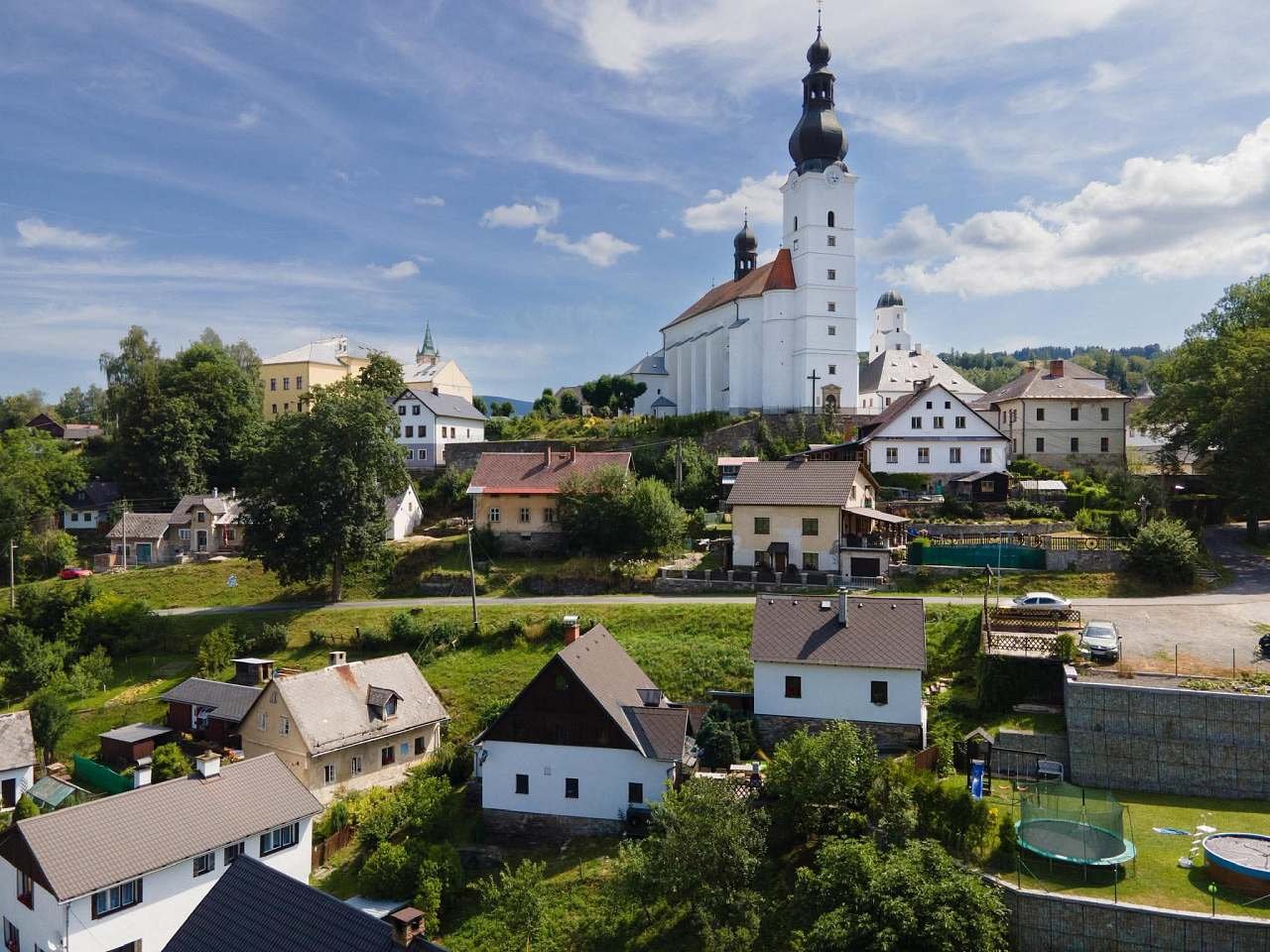 Pohled na Penzion Zoe a obec Brannou s kostelem sv. Michaela z dronu.